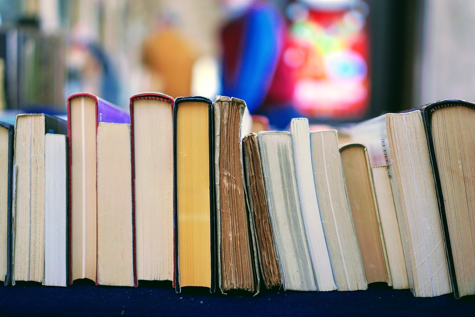 pile of books lined up along table